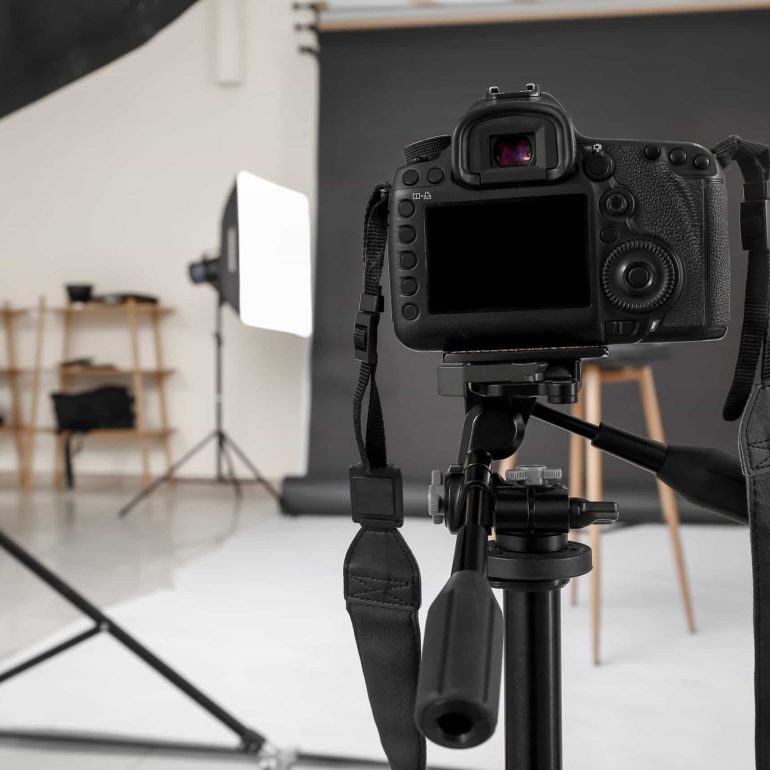 Modern camera in professional photo studio